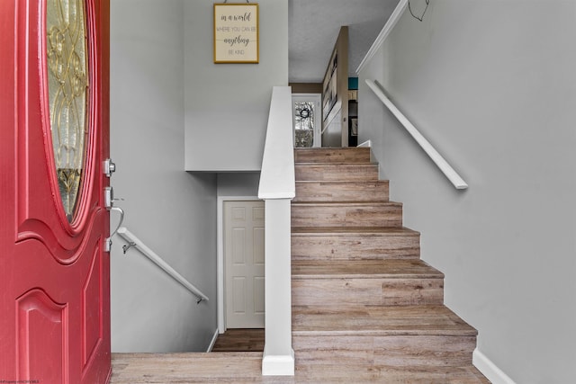 stairs featuring hardwood / wood-style flooring