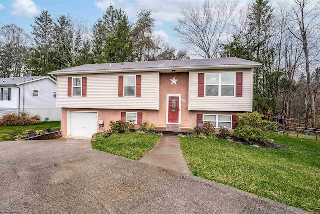 split foyer home with a front yard and a garage