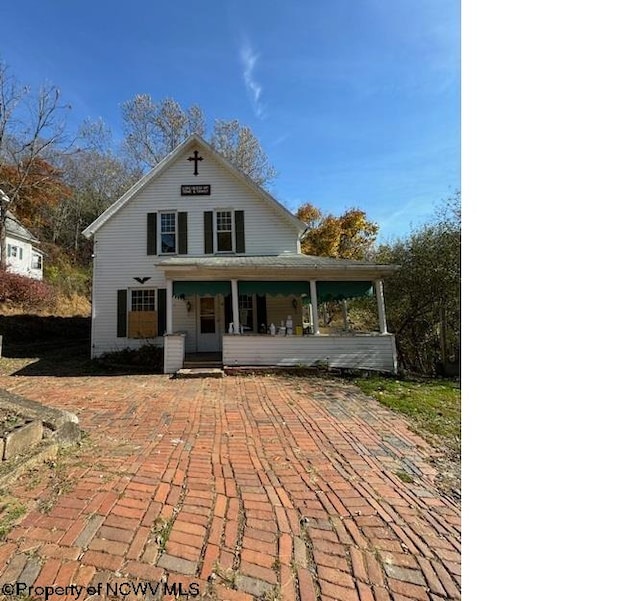 rear view of house featuring covered porch