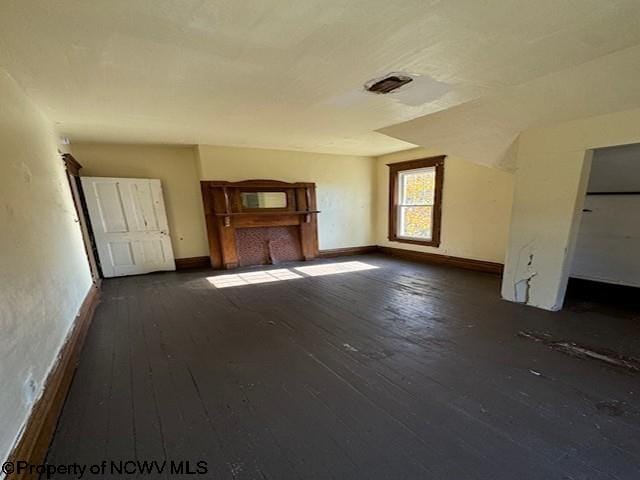 unfurnished living room featuring dark hardwood / wood-style floors