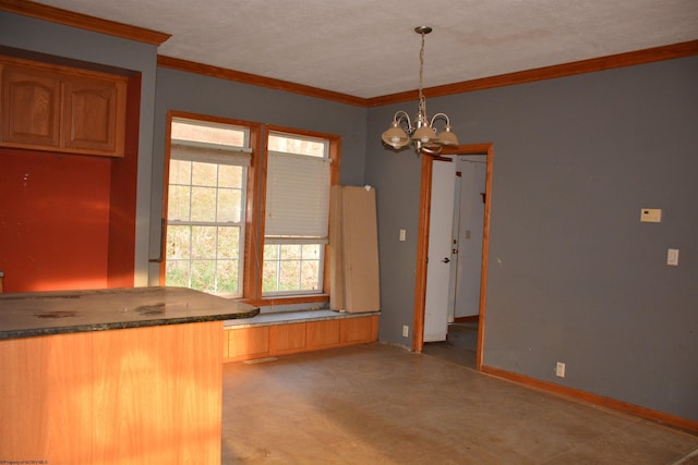 kitchen with crown molding, pendant lighting, a textured ceiling, and an inviting chandelier