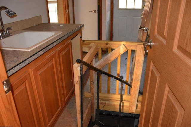 kitchen with tile patterned flooring, a healthy amount of sunlight, and sink