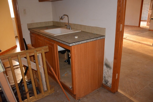 kitchen featuring light tile patterned floors and sink