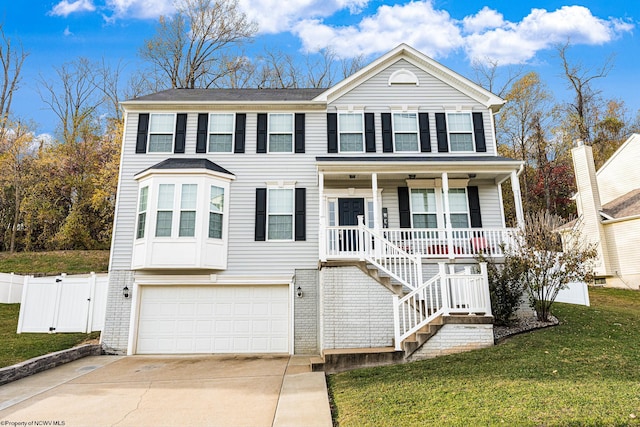 view of front of house featuring a garage, covered porch, and a front yard