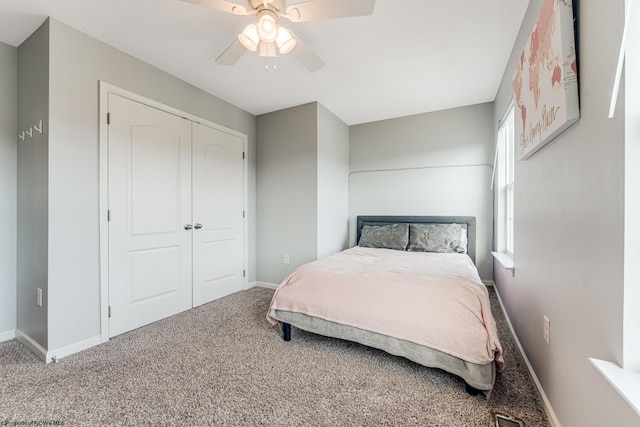 carpeted bedroom featuring ceiling fan and a closet