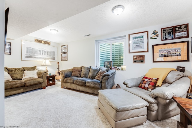 carpeted living room featuring a textured ceiling