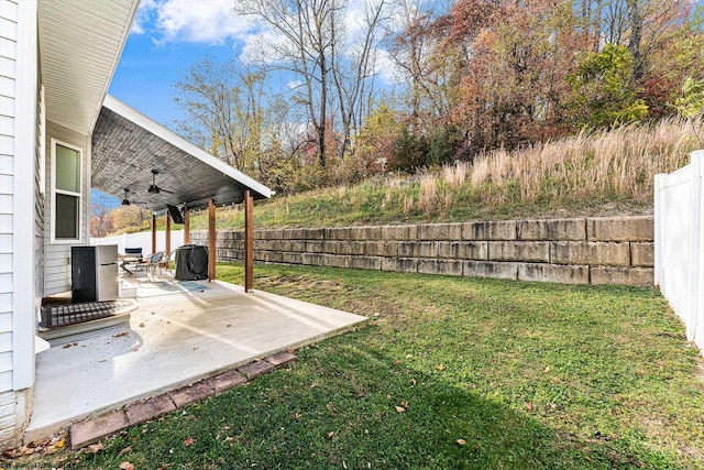 view of yard featuring a patio area and ceiling fan