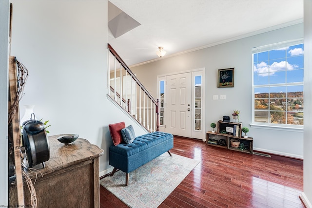 foyer with wood-type flooring, plenty of natural light, and crown molding