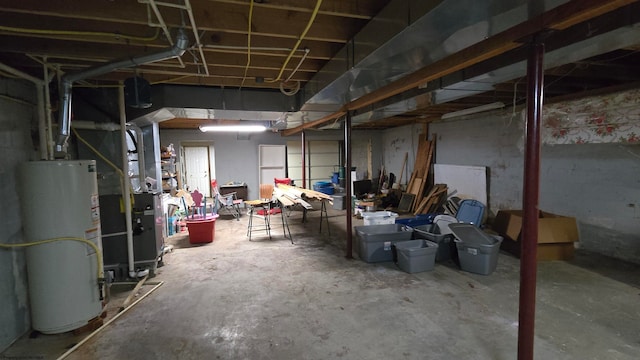 basement featuring gas water heater and heating unit