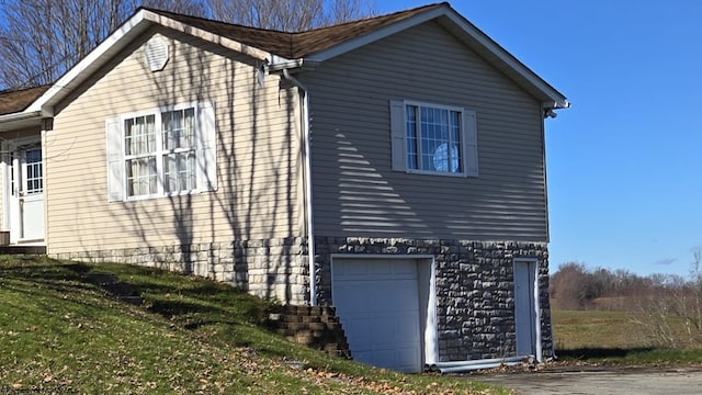 view of home's exterior featuring a yard and a garage