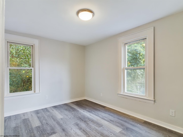 unfurnished room with hardwood / wood-style floors