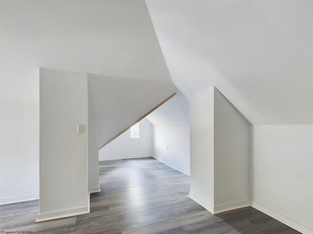 additional living space with dark hardwood / wood-style floors and lofted ceiling