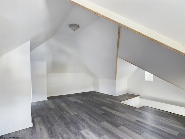 additional living space featuring dark hardwood / wood-style flooring and lofted ceiling