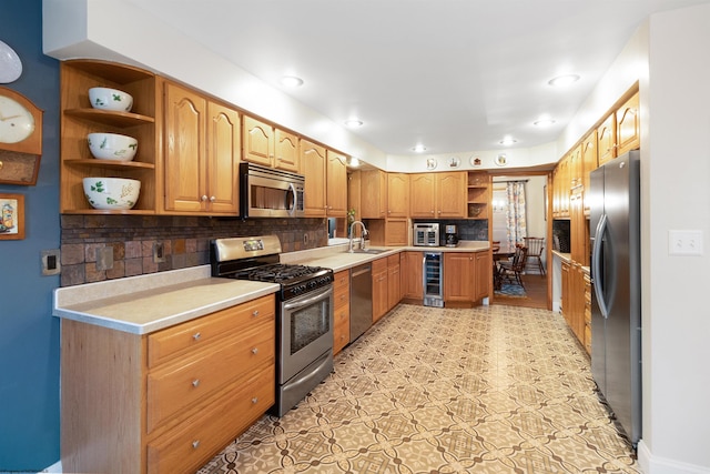 kitchen with appliances with stainless steel finishes, backsplash, sink, light tile patterned floors, and wine cooler