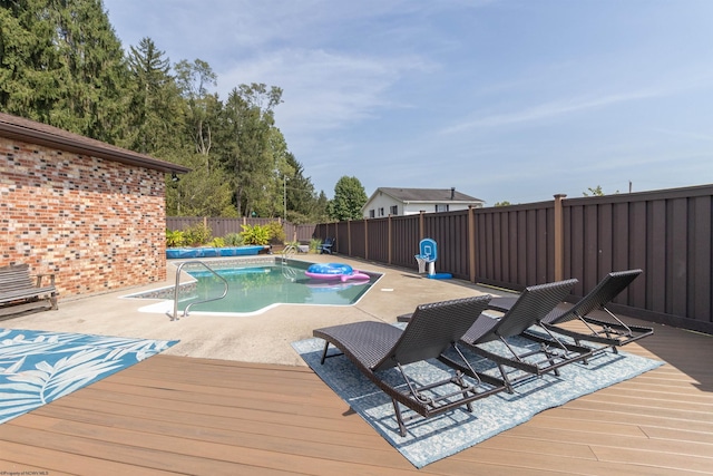 view of pool with a patio and a wooden deck