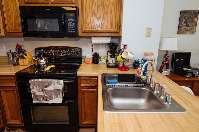 kitchen featuring sink and black appliances