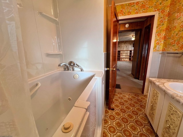 bathroom with a bathing tub, vanity, and ceiling fan