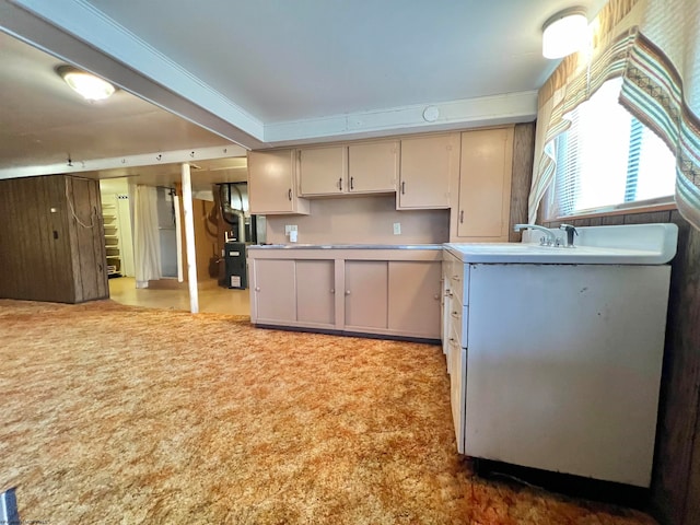 kitchen featuring carpet floors, sink, and heating unit