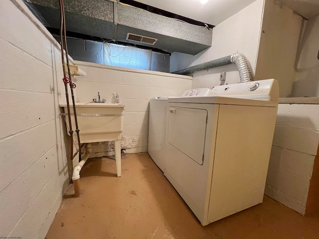 laundry room with washing machine and dryer and sink