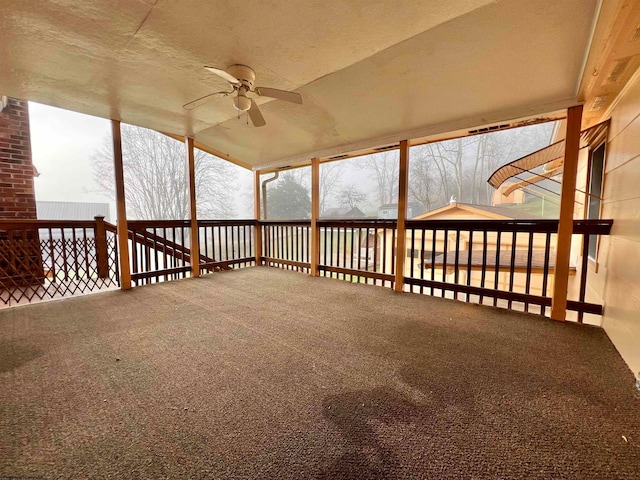 unfurnished sunroom featuring vaulted ceiling and ceiling fan