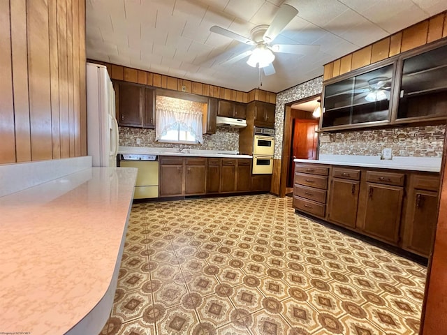 kitchen featuring white appliances, sink, decorative backsplash, ceiling fan, and dark brown cabinetry