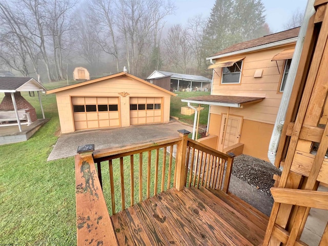 deck featuring a yard, a garage, an outdoor structure, and a carport