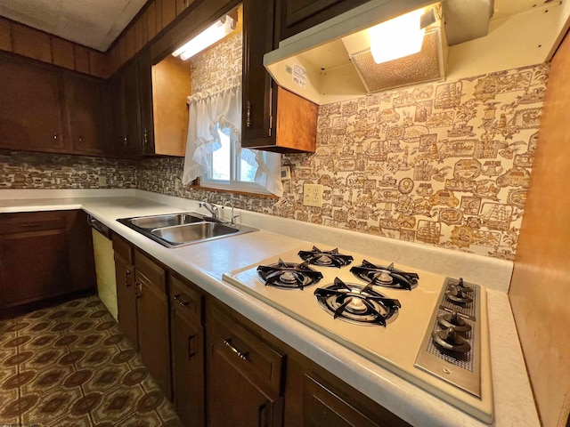 kitchen featuring white gas cooktop, sink, decorative backsplash, dark brown cabinetry, and extractor fan