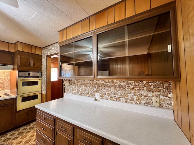 kitchen featuring wooden walls and white appliances