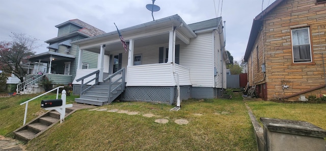 bungalow-style house with a front lawn and covered porch