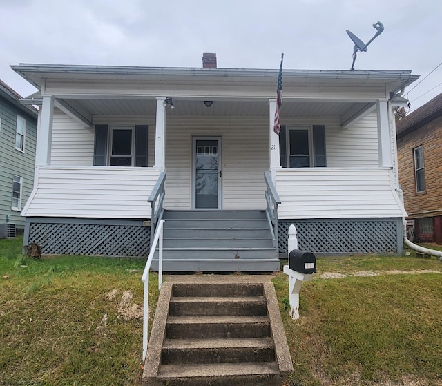 manufactured / mobile home featuring a front lawn and a porch