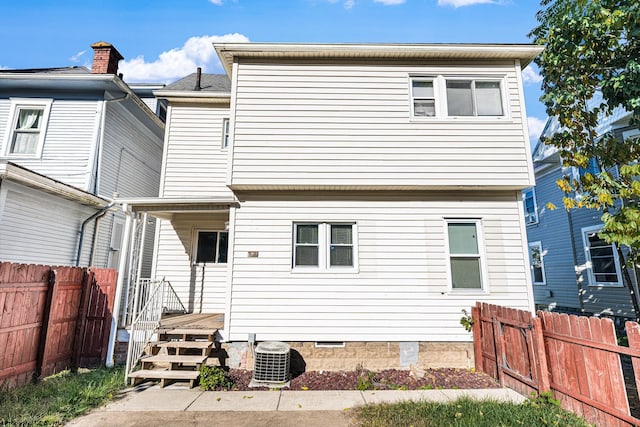 back of house featuring central AC unit