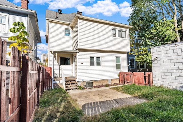 back of house featuring cooling unit