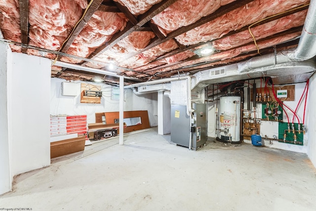 basement featuring gas water heater and heating unit