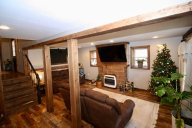 living room featuring dark hardwood / wood-style flooring and heating unit