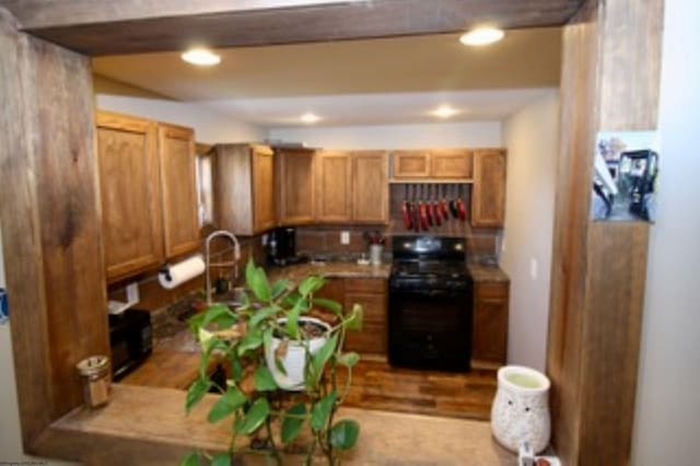 kitchen with light hardwood / wood-style floors and black range oven