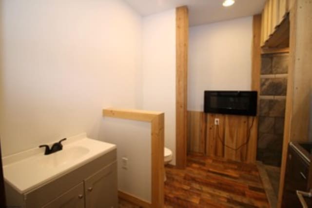 bathroom with hardwood / wood-style floors and toilet