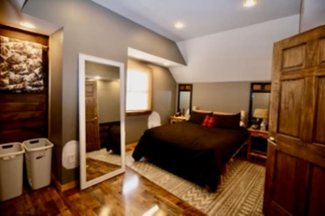 bedroom with dark hardwood / wood-style flooring, a closet, and lofted ceiling