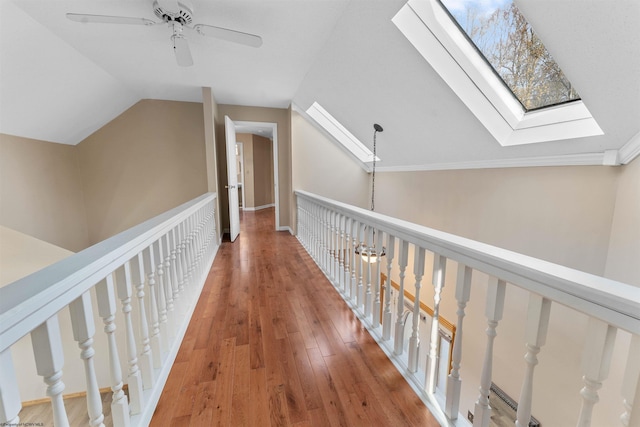 hall with hardwood / wood-style floors and vaulted ceiling