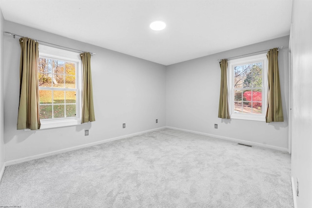 spare room featuring light colored carpet