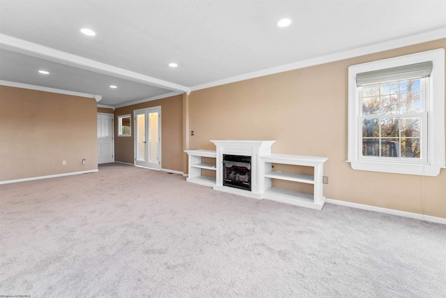 unfurnished living room with light colored carpet and ornamental molding