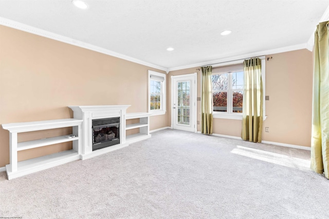 unfurnished living room with carpet and crown molding