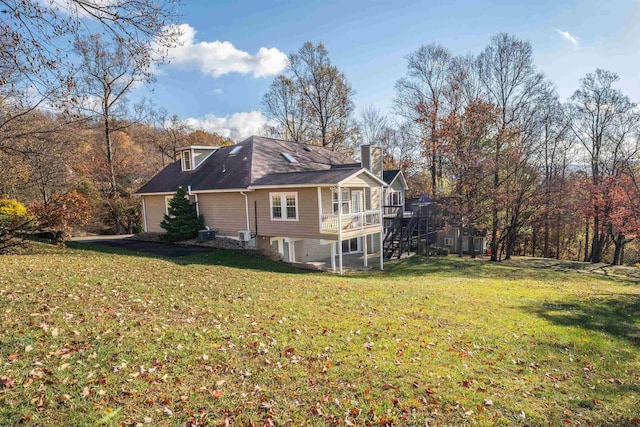 view of home's exterior with a deck, cooling unit, and a lawn