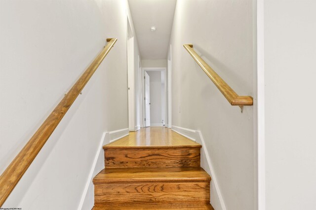 staircase with hardwood / wood-style floors