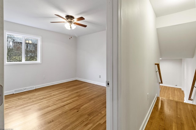 empty room with ceiling fan and light wood-type flooring