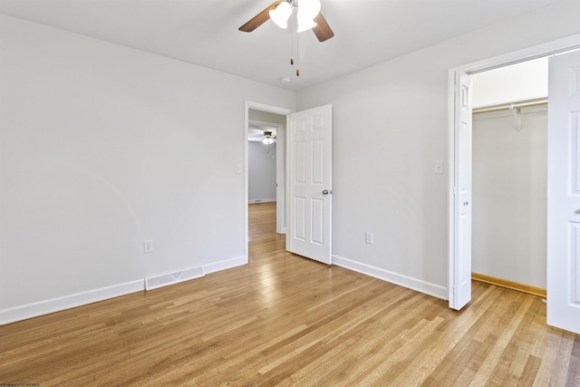 unfurnished bedroom with ceiling fan, light hardwood / wood-style floors, and a closet