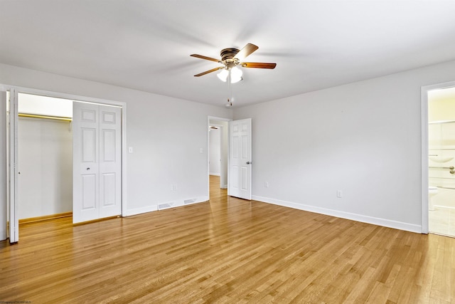 unfurnished bedroom with connected bathroom, ceiling fan, a closet, and light wood-type flooring