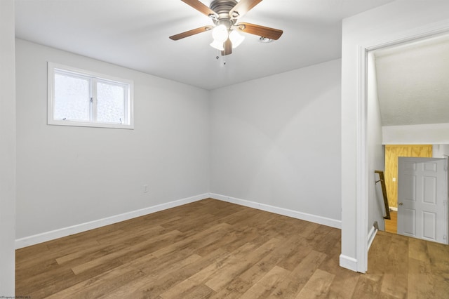 unfurnished room featuring ceiling fan, lofted ceiling, and light wood-type flooring