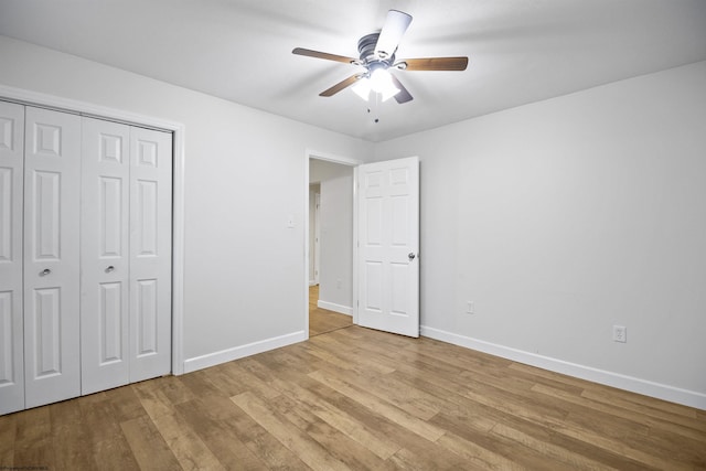 unfurnished bedroom with ceiling fan, a closet, and light wood-type flooring