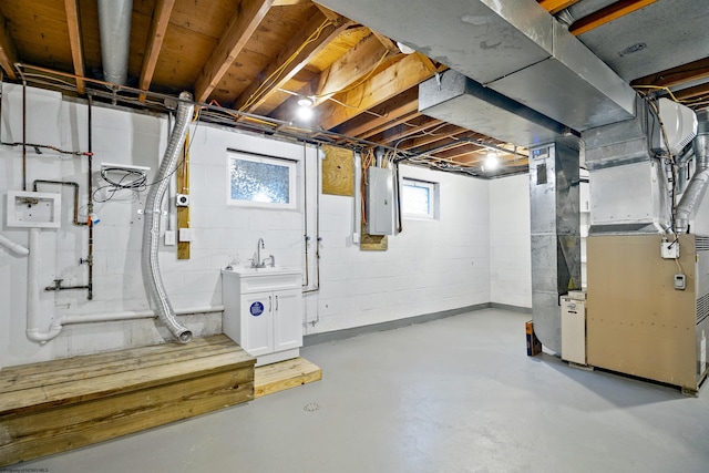 basement with sink, electric panel, and heating unit