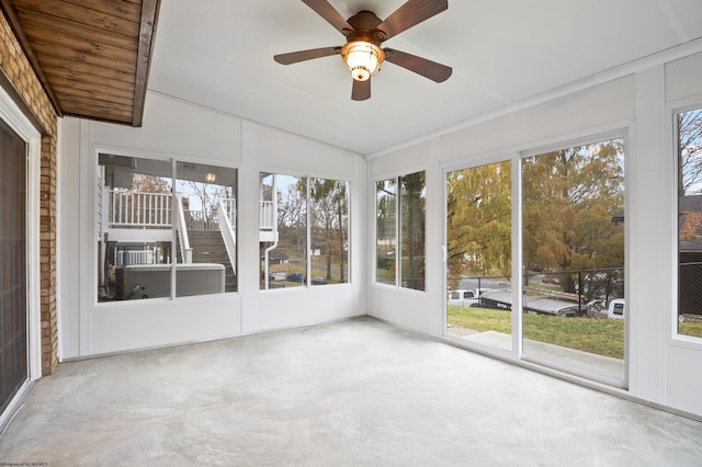 unfurnished sunroom with plenty of natural light, lofted ceiling, and ceiling fan